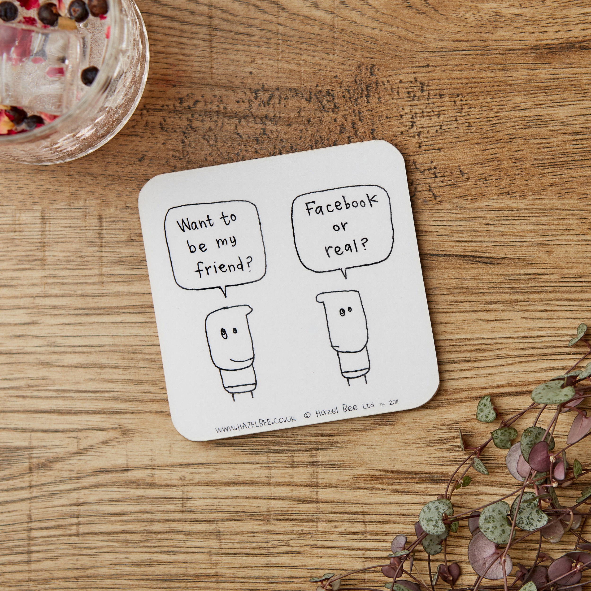 A stylish Facebook Friend Coaster made from eco-friendly cork and hardboard, featuring a modern design suitable for any beverage.