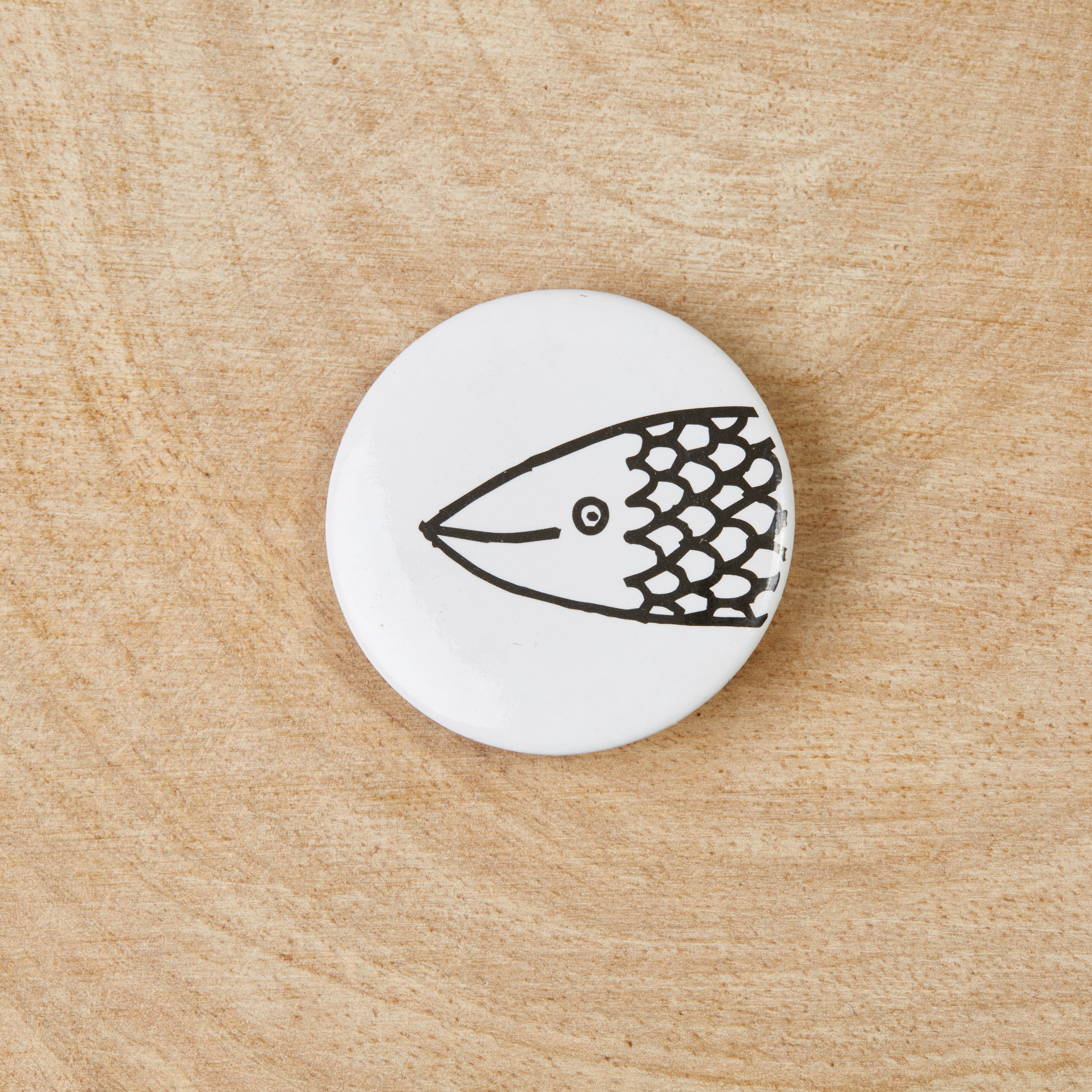 A set of eco-friendly Friendship Fish badges featuring a black design on a white background, measuring 38mm in width.