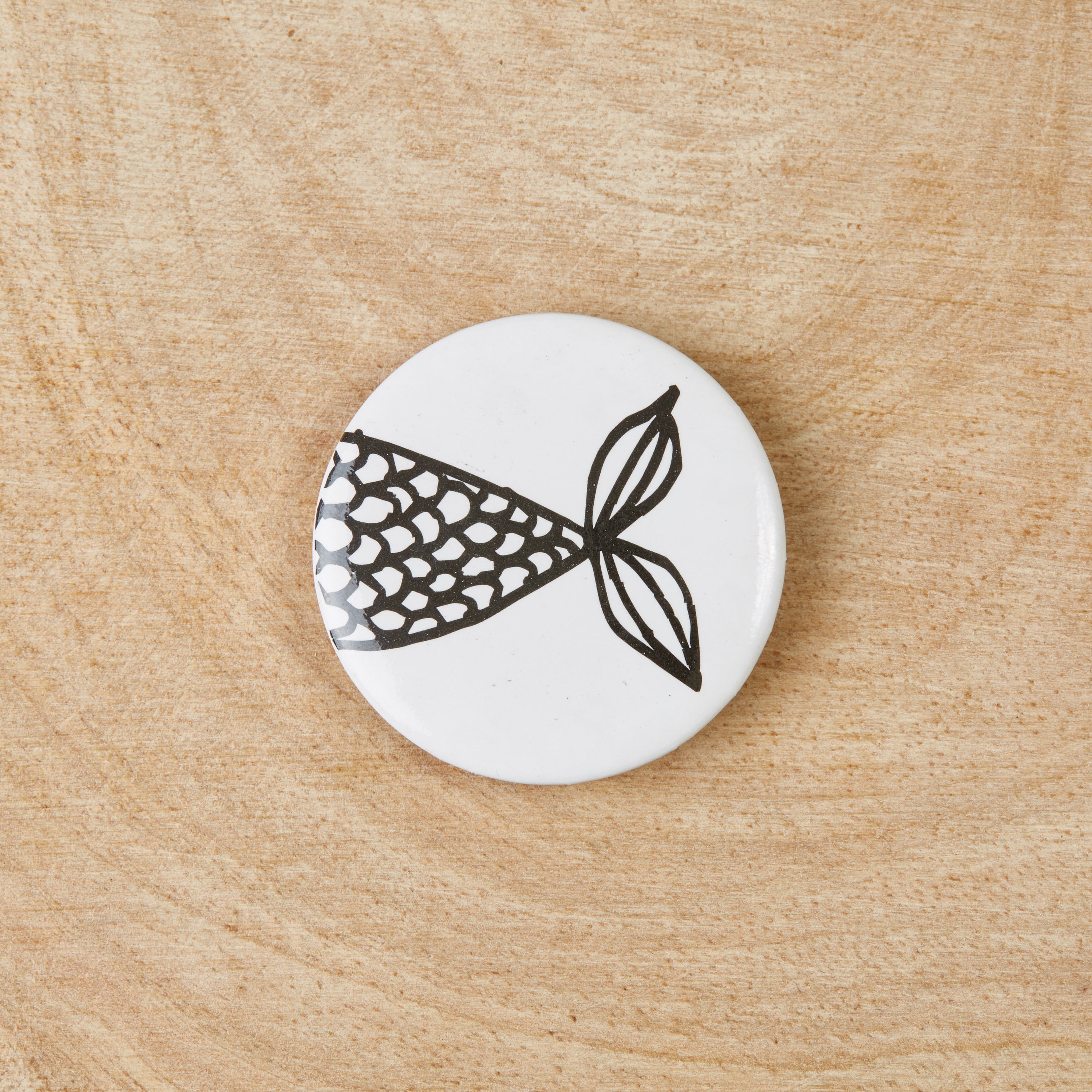 A set of eco-friendly Friendship Fish badges featuring a black design on a white background, measuring 38mm in width.