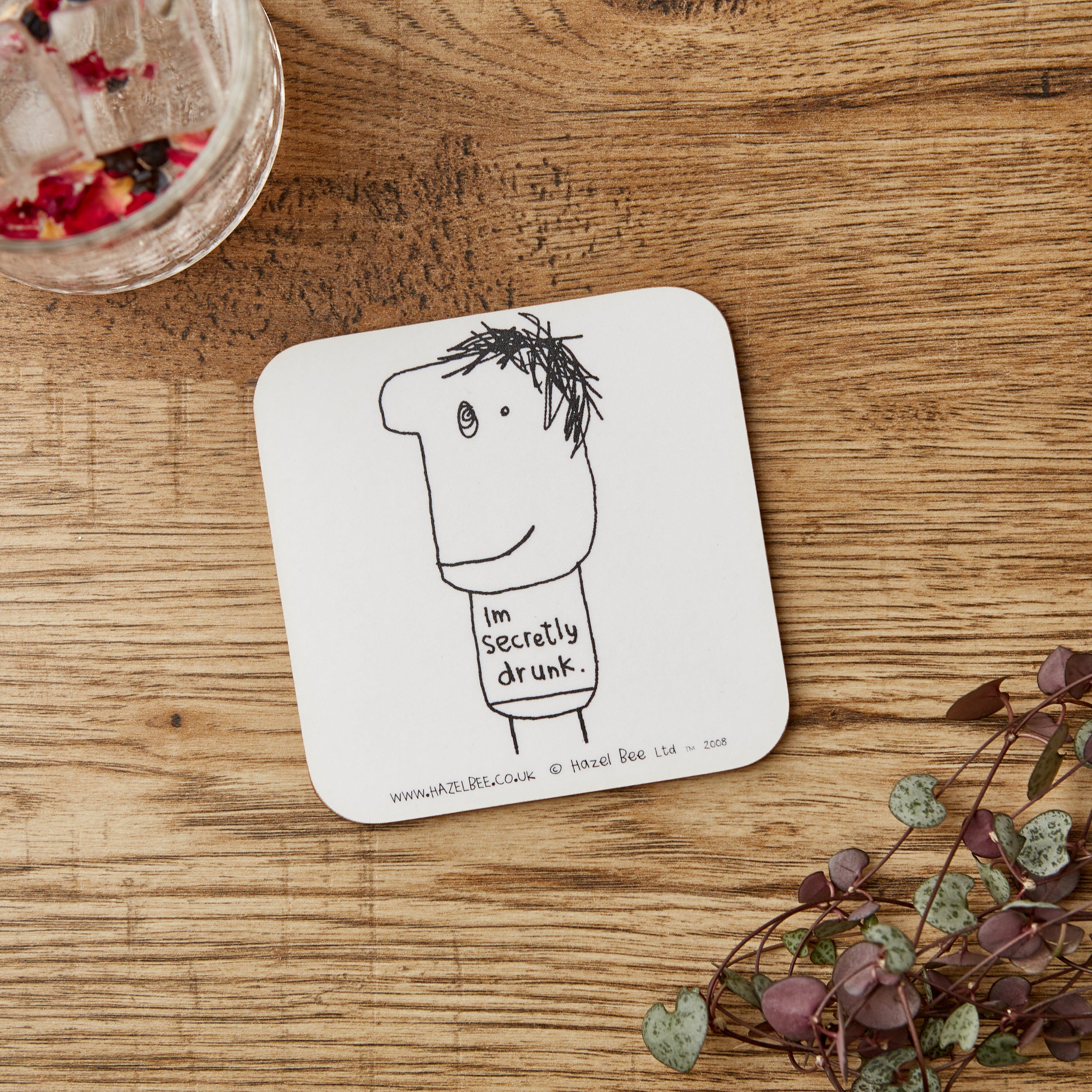 Eco-friendly Secretly Drunk Coaster made from cork and hardboard, featuring a stylish design suitable for home or office use.