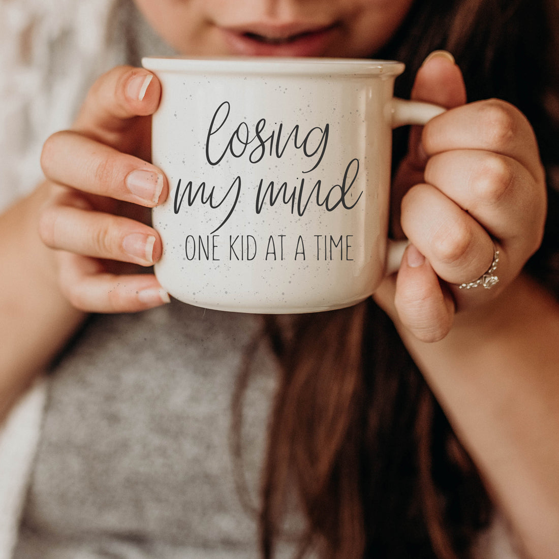 A 14.5oz ceramic campfire style coffee mug with a humorous quote for parents, featuring a light ivory color with speckles and black lettering.