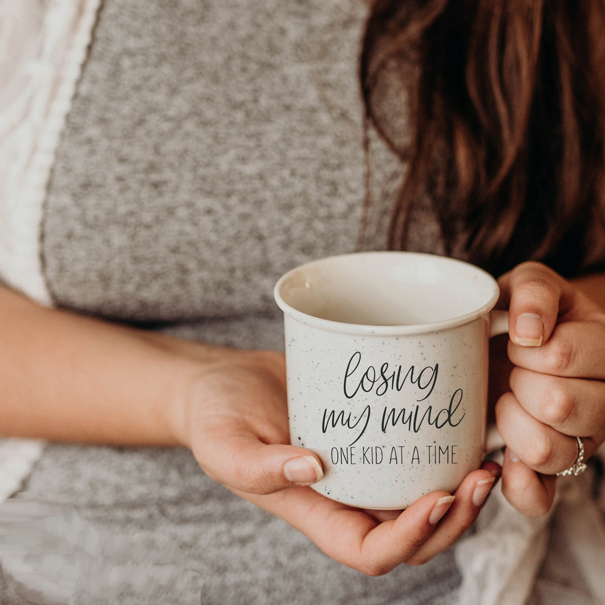 A 14.5oz ceramic campfire style coffee mug with a humorous quote for parents, featuring a light ivory color with speckles and black lettering.