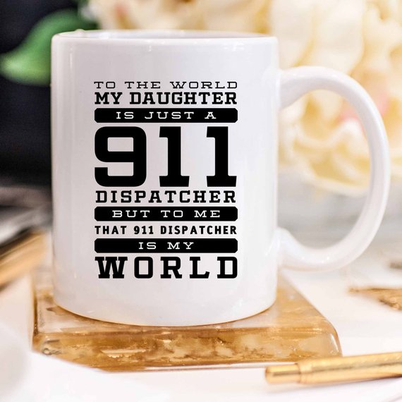 A white ceramic mug featuring a vibrant design celebrating 911 dispatchers, printed on both sides.