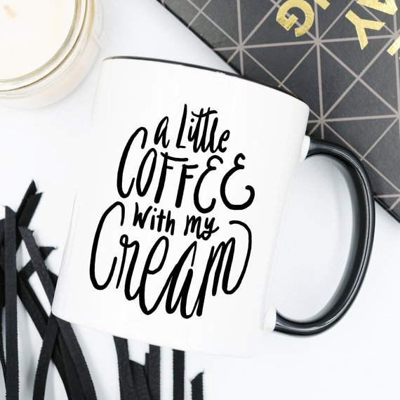 A humorous coffee mug with the phrase 'A Little Coffee With My Cream' printed on it, showcasing a fun design perfect for coffee lovers.