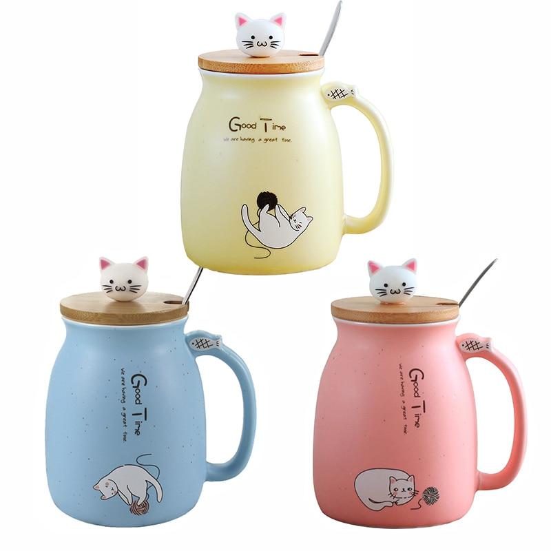 A colorful ceramic coffee mug featuring an adorable cat cartoon design, available in pink, yellow, and blue.