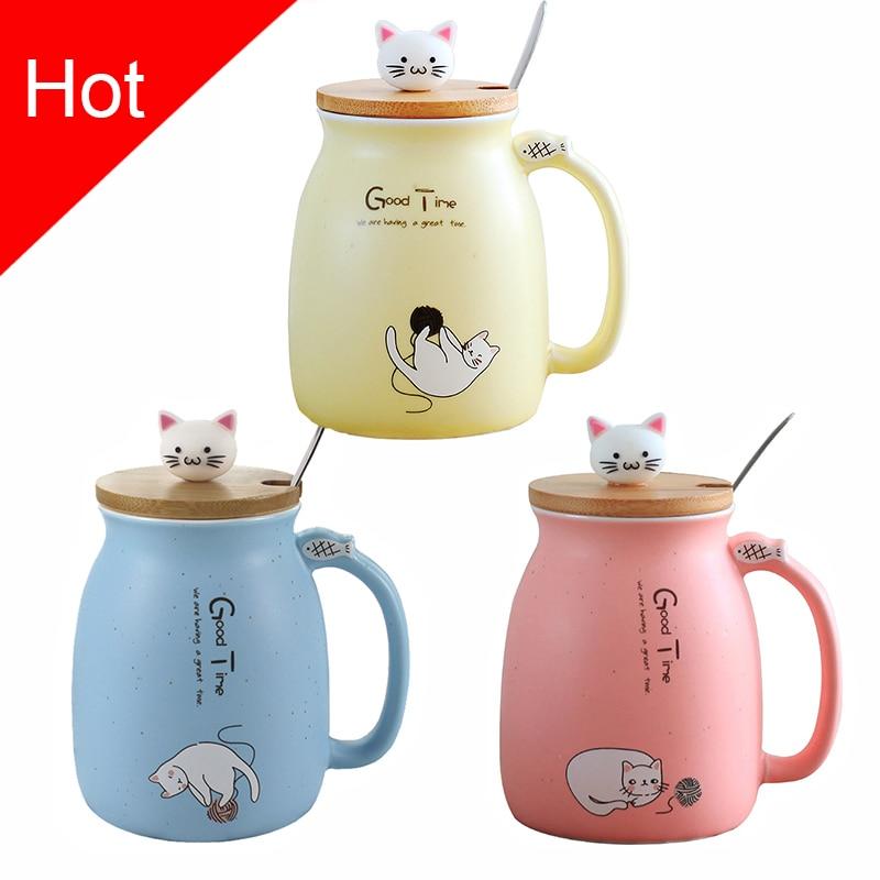 A colorful ceramic coffee mug featuring an adorable cat cartoon design, available in pink, yellow, and blue.