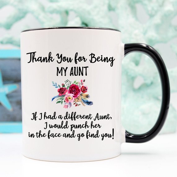 A beautiful white ceramic mug designed for aunts, featuring a vibrant printed design on both sides, available in 11 and 15 oz sizes.