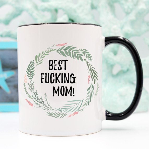 A white ceramic mug with 'Best Fucking Mom' printed on both sides, showcasing a vibrant design.