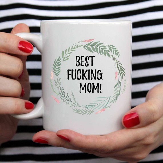 A white ceramic mug with 'Best Fucking Mom' printed on both sides, showcasing a vibrant design.