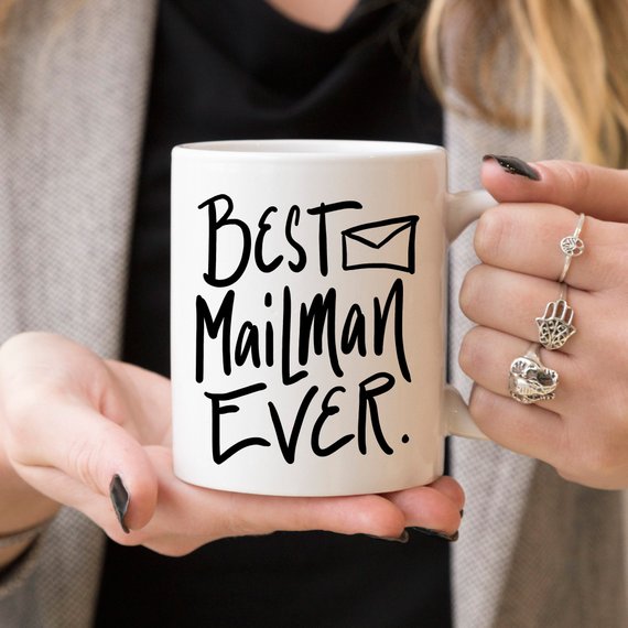 A ceramic coffee mug featuring the text 'Best Mail Man Ever' in a fun design, perfect for postal workers and coffee lovers.