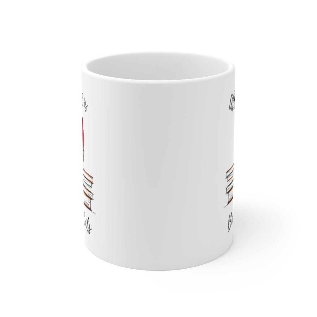 A white ceramic mug with the phrase 'All I Need is Books & Cats' printed on it, perfect for book lovers.