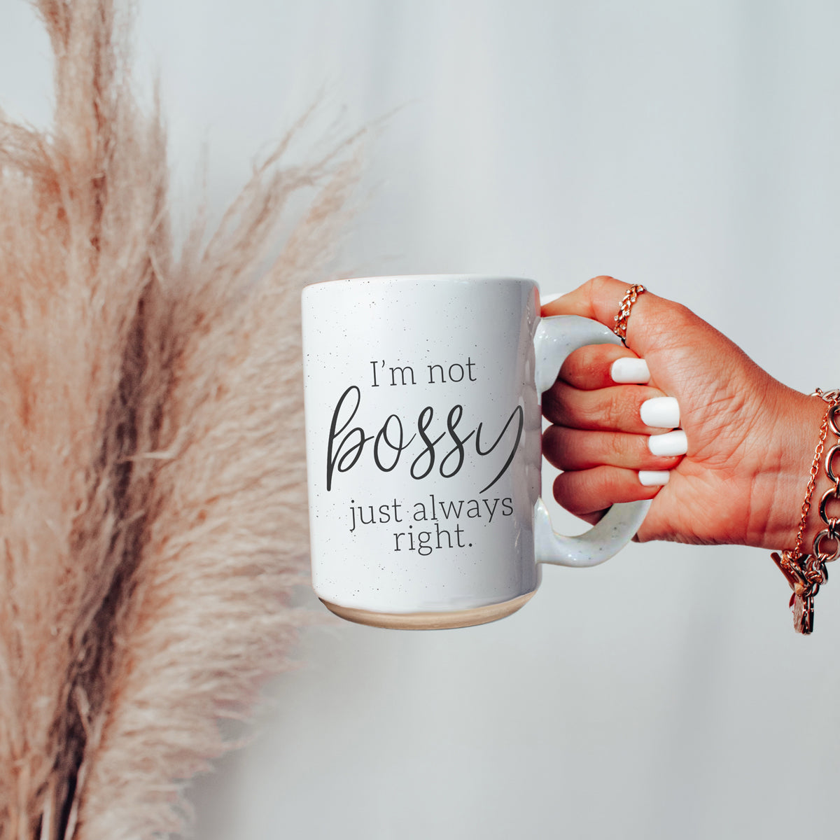 A stylish off-white ceramic coffee mug with dark speckles, featuring the bold text 'I'm Not Bossy, Just Always Right' on both sides.