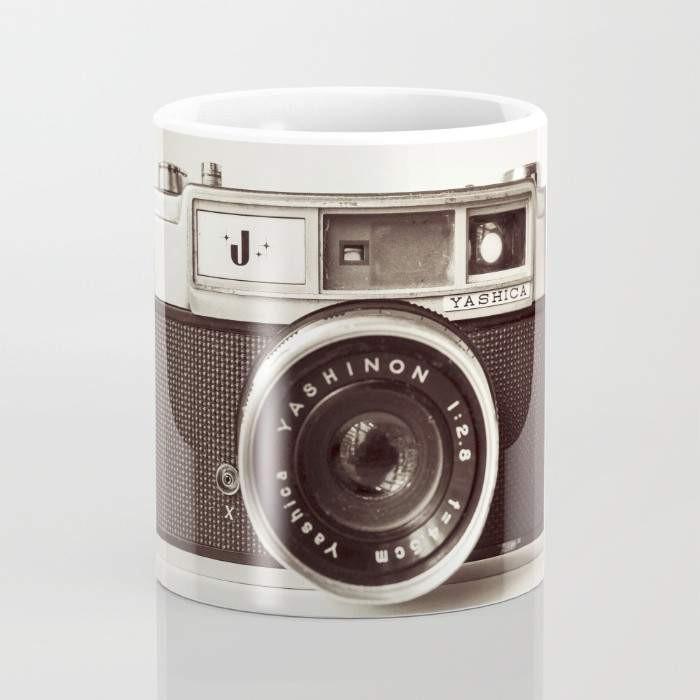 A stylish 15-ounce ceramic Camera Mug featuring wrap-around photography-themed art and a large handle for easy gripping.