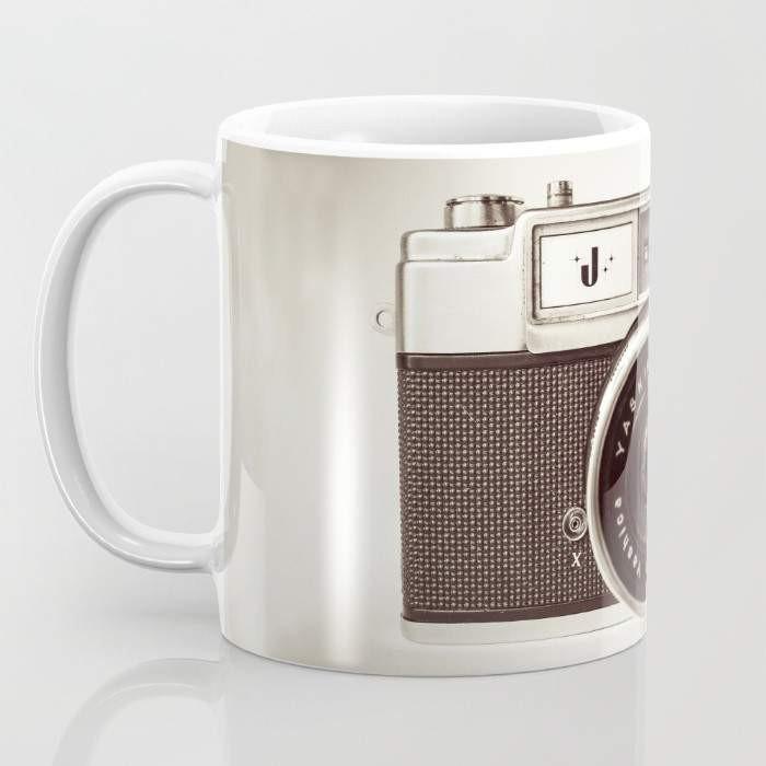 A stylish 15-ounce ceramic Camera Mug featuring wrap-around photography-themed art and a large handle for easy gripping.