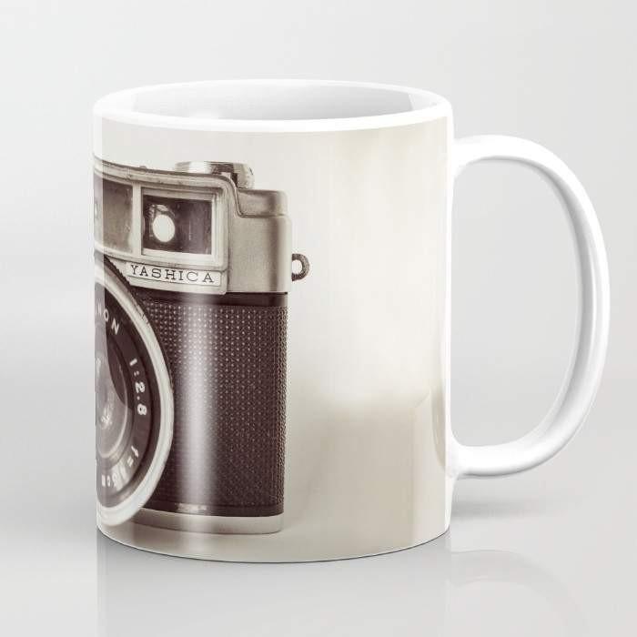 A stylish 15-ounce ceramic Camera Mug featuring wrap-around photography-themed art and a large handle for easy gripping.