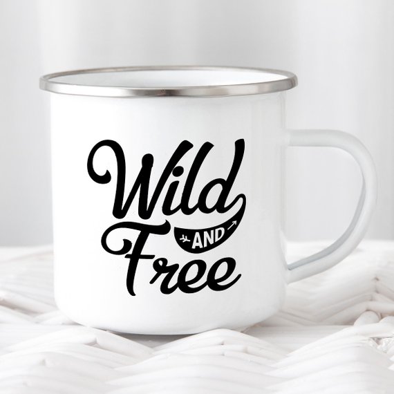 White enamel camping mug with stainless steel rim featuring 'Wild and Free' design on both sides, perfect for outdoor adventures.