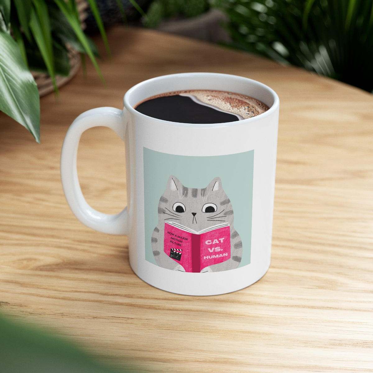 A humorous Cat Vs. Human Funny Mug made of white ceramic, featuring a playful design, perfect for coffee and tea lovers.