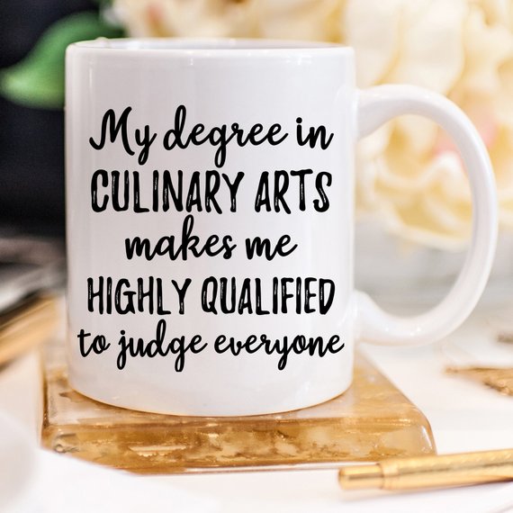 A high-quality white ceramic Chef Mug featuring a vibrant design, perfect for culinary arts enthusiasts, shown against a clean background.