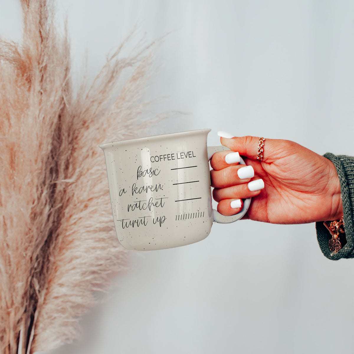 A stylish Don't be a Karen Coffee Mug with a white sesame glaze, featuring black lettering and speckles, designed for daily use.