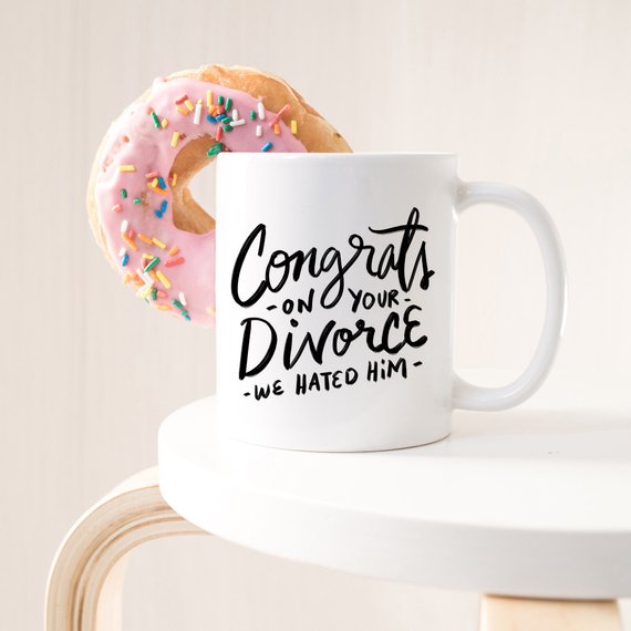 Congrats Divorce Mug featuring a vibrant design on a white ceramic mug with a black handle and rim, perfect for celebrating new beginnings.