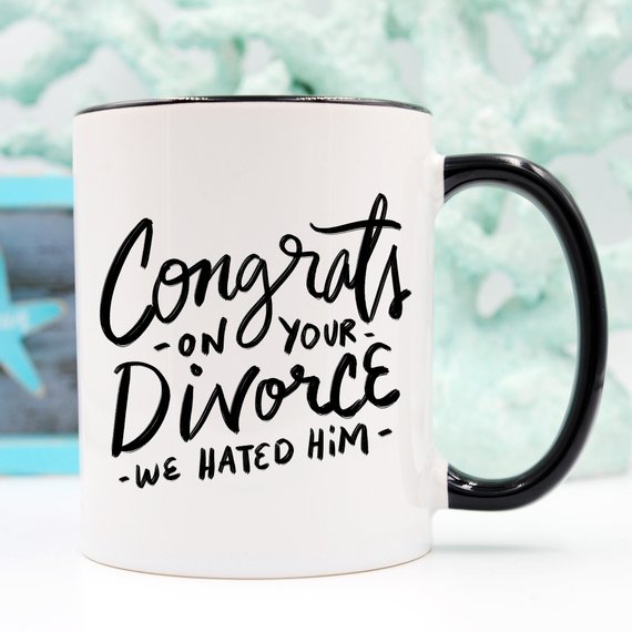 Congrats Divorce Mug featuring a vibrant design on a white ceramic mug with a black handle and rim, perfect for celebrating new beginnings.