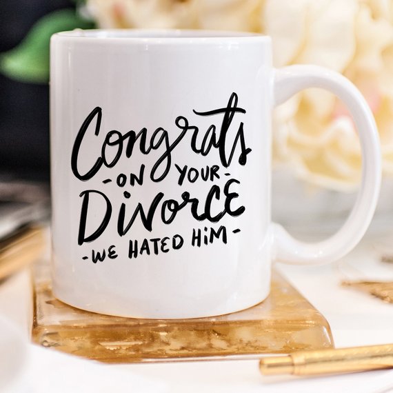 Congrats Divorce Mug featuring a vibrant design on a white ceramic mug with a black handle and rim, perfect for celebrating new beginnings.