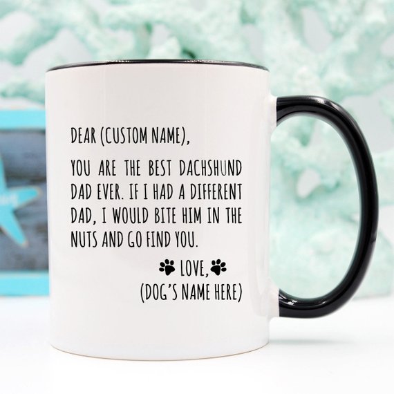 A stylish white ceramic mug featuring a vibrant Dachshund design, perfect for Dachshund dads, available in 11 and 15 oz sizes.