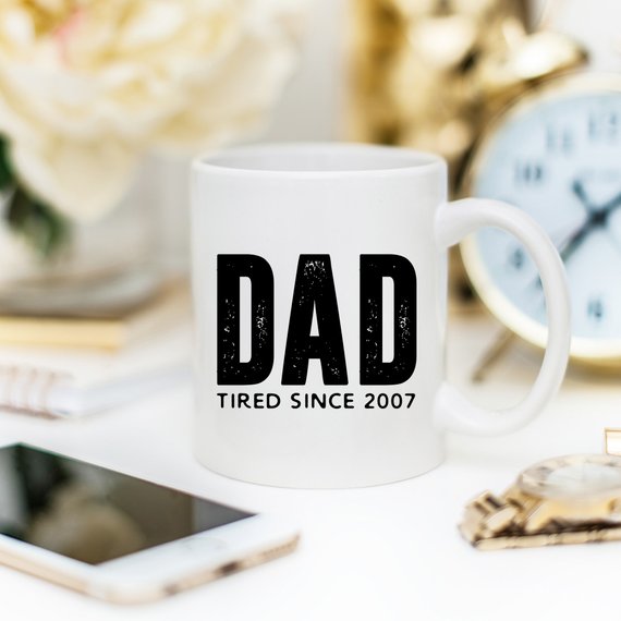 A humorous coffee mug with the text 'Dad Tired Since 2007', crafted from high-quality ceramic, perfect for Father's Day gifts.