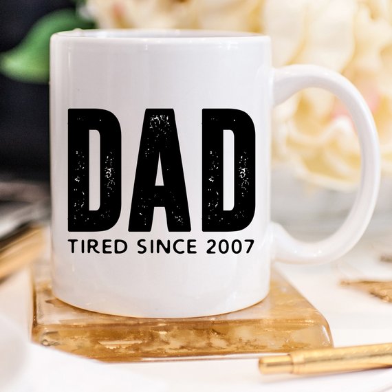 A humorous coffee mug with the text 'Dad Tired Since 2007', crafted from high-quality ceramic, perfect for Father's Day gifts.