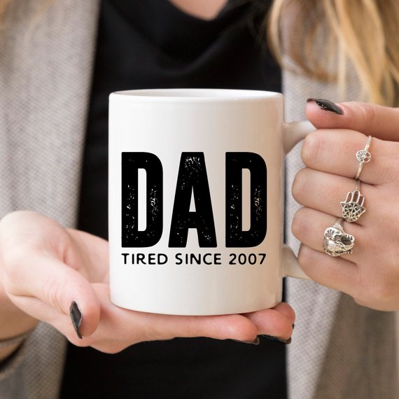 A humorous coffee mug with the text 'Dad Tired Since 2007', crafted from high-quality ceramic, perfect for Father's Day gifts.