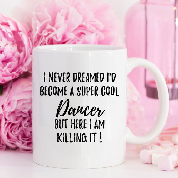 A stylish white ceramic mug featuring a vibrant dancer design on both sides, perfect for dance enthusiasts.