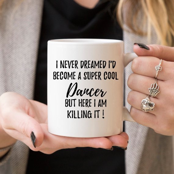 A stylish white ceramic mug featuring a vibrant dancer design on both sides, perfect for dance enthusiasts.