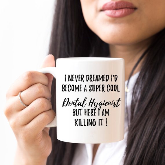 A white ceramic Dental Hygienist Mug featuring a vibrant design on both sides, perfect for coffee or tea.