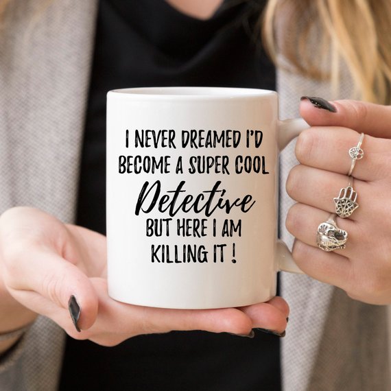 A stylish white ceramic mug featuring a detective-themed design, printed on both sides, perfect for coffee lovers and detectives.