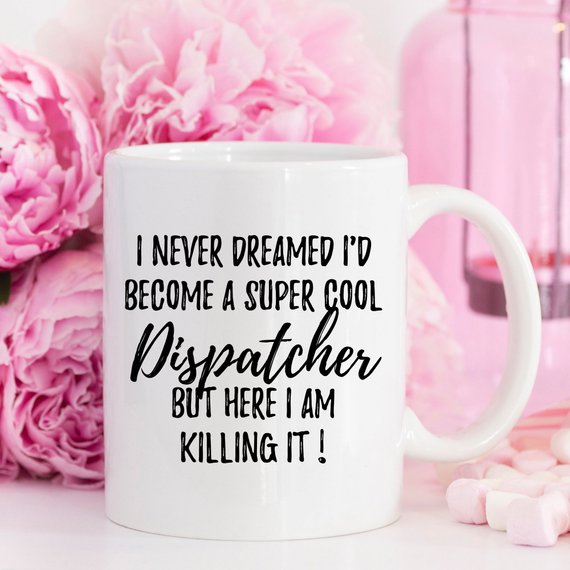 A stylish white ceramic mug featuring a vibrant dispatcher-themed design on both sides, perfect for coffee or tea.