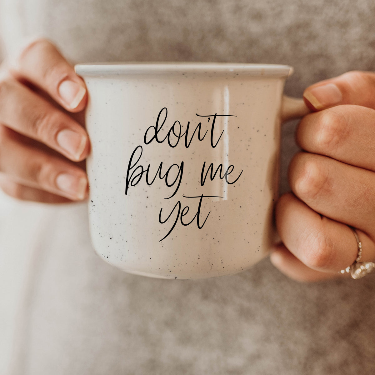 Don't Bug Me Yet 14.5oz ceramic coffee mug with double-sided design, featuring light ivory color and black lettering.