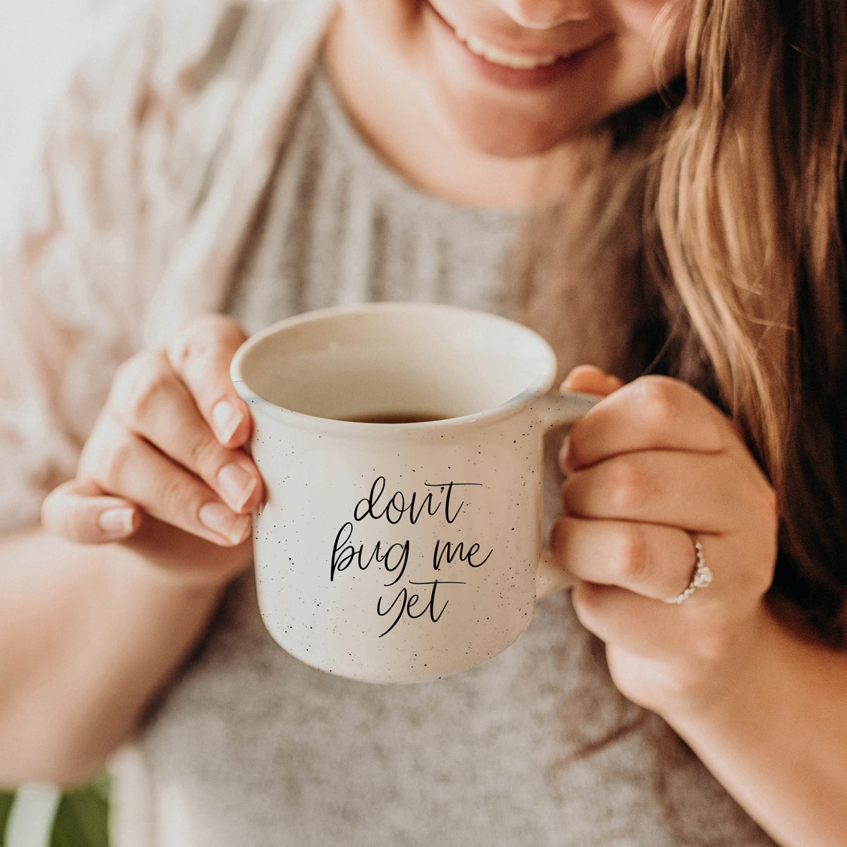 Don't Bug Me Yet 14.5oz ceramic coffee mug with double-sided design, featuring light ivory color and black lettering.