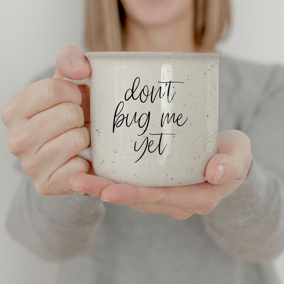 Don't Bug Me Yet 14.5oz ceramic coffee mug with double-sided design, featuring light ivory color and black lettering.