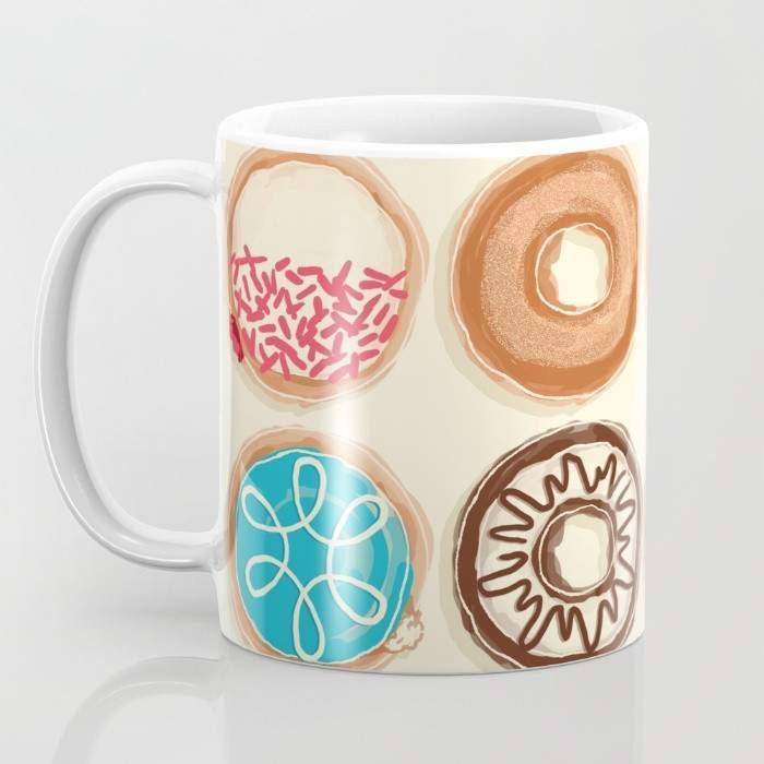 A vibrant 15-ounce ceramic mug featuring a whimsical doughnut design, perfect for coffee or tea lovers, with a large handle for easy gripping.