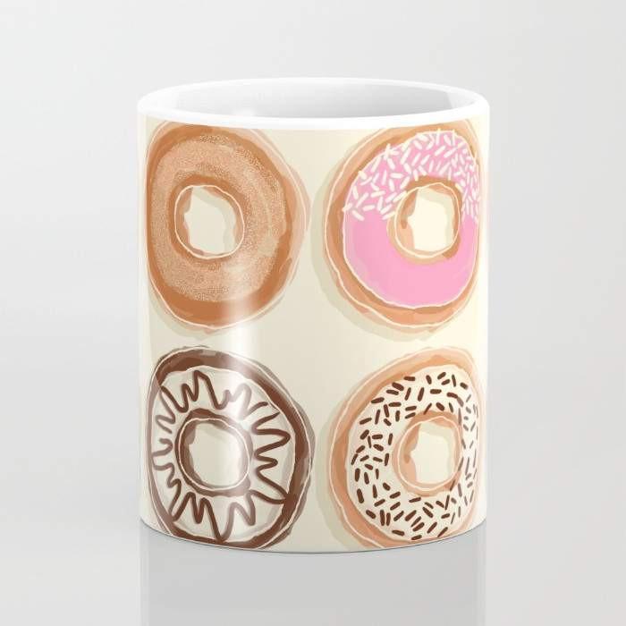 A vibrant 15-ounce ceramic mug featuring a whimsical doughnut design, perfect for coffee or tea lovers, with a large handle for easy gripping.