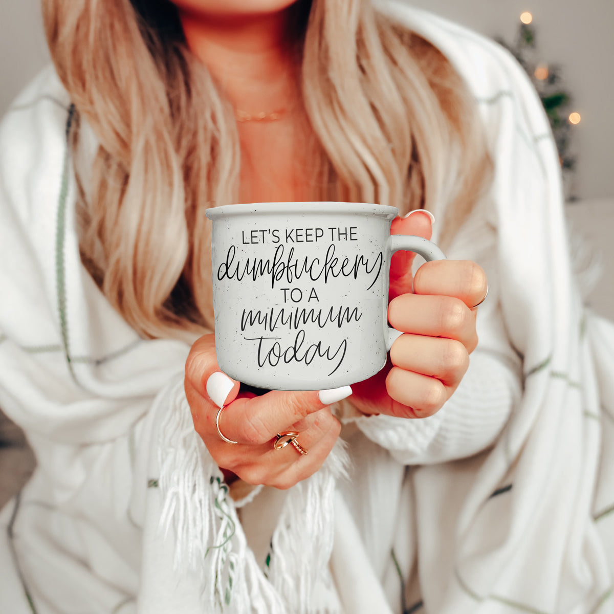 Dumbf**kery Mug featuring a humorous phrase in black lettering on a light ivory ceramic background with speckles.