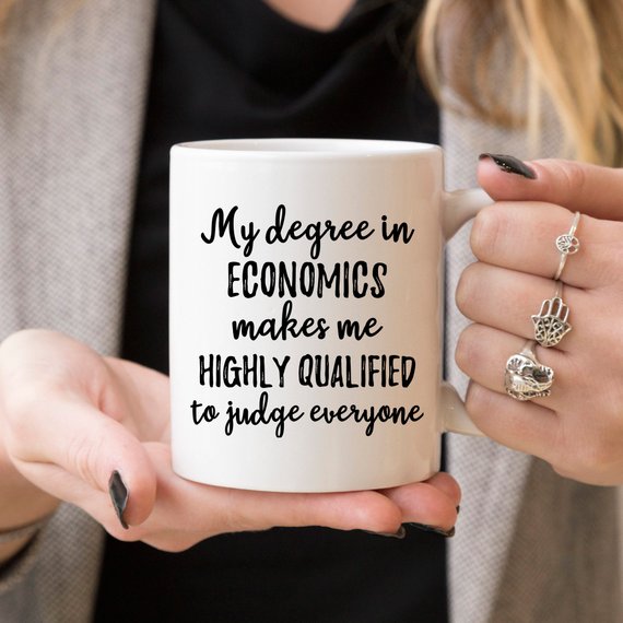 A white ceramic mug featuring vibrant economics-themed designs on both sides, perfect for coffee or tea.