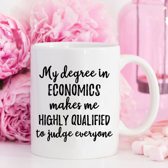 A white ceramic mug featuring vibrant economics-themed designs on both sides, perfect for coffee or tea.