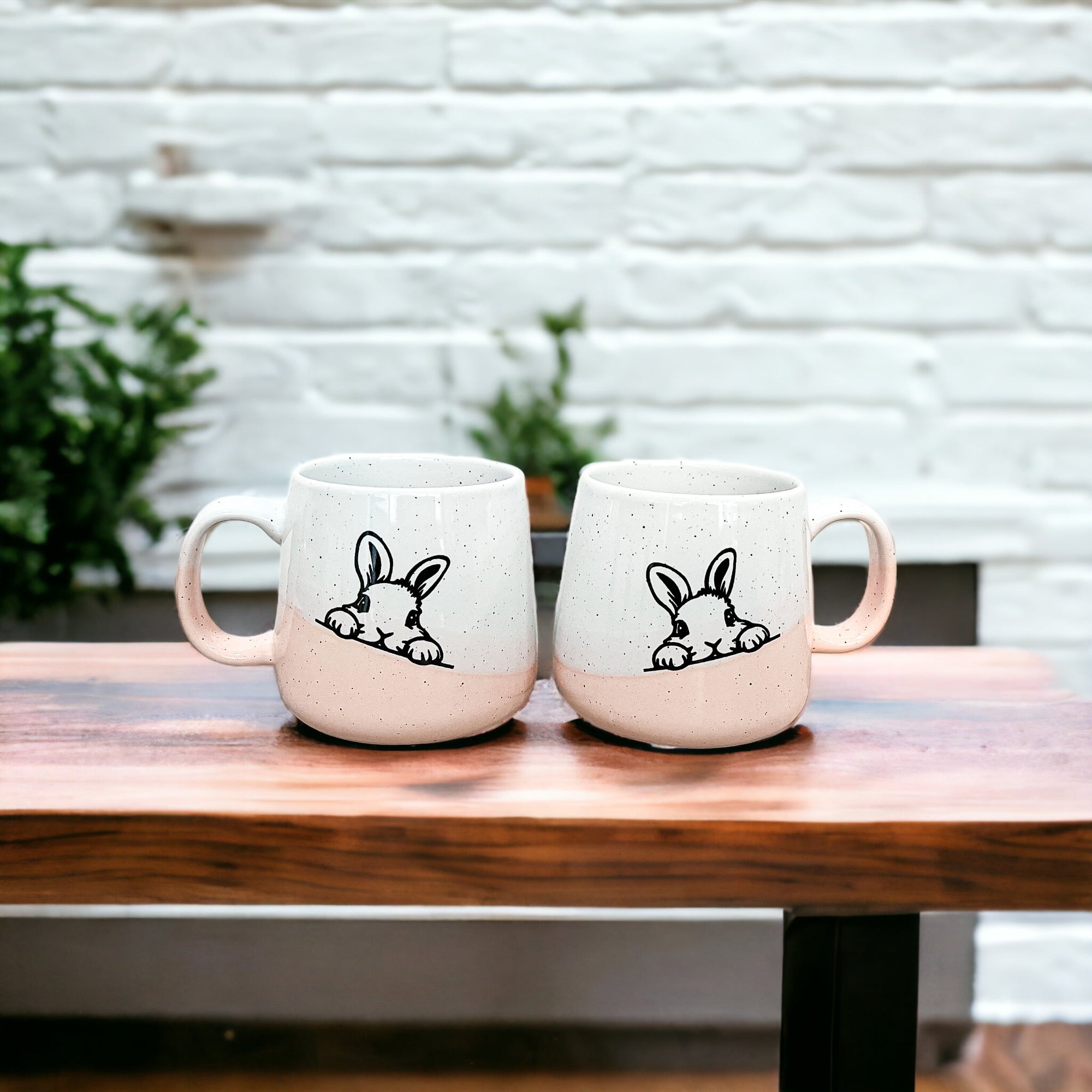 Handcrafted ceramic mug featuring a bunny silhouette and pastel pink base, perfect for coffee or tea.