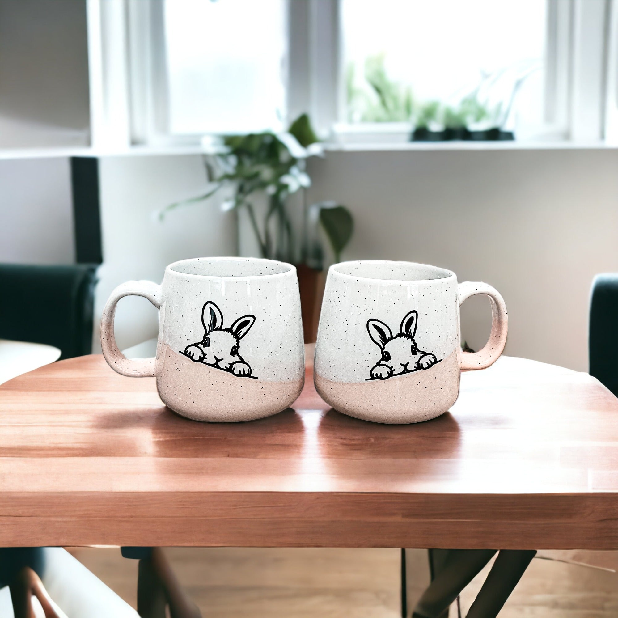 Handcrafted ceramic mug featuring a bunny silhouette and pastel pink base, perfect for coffee or tea.