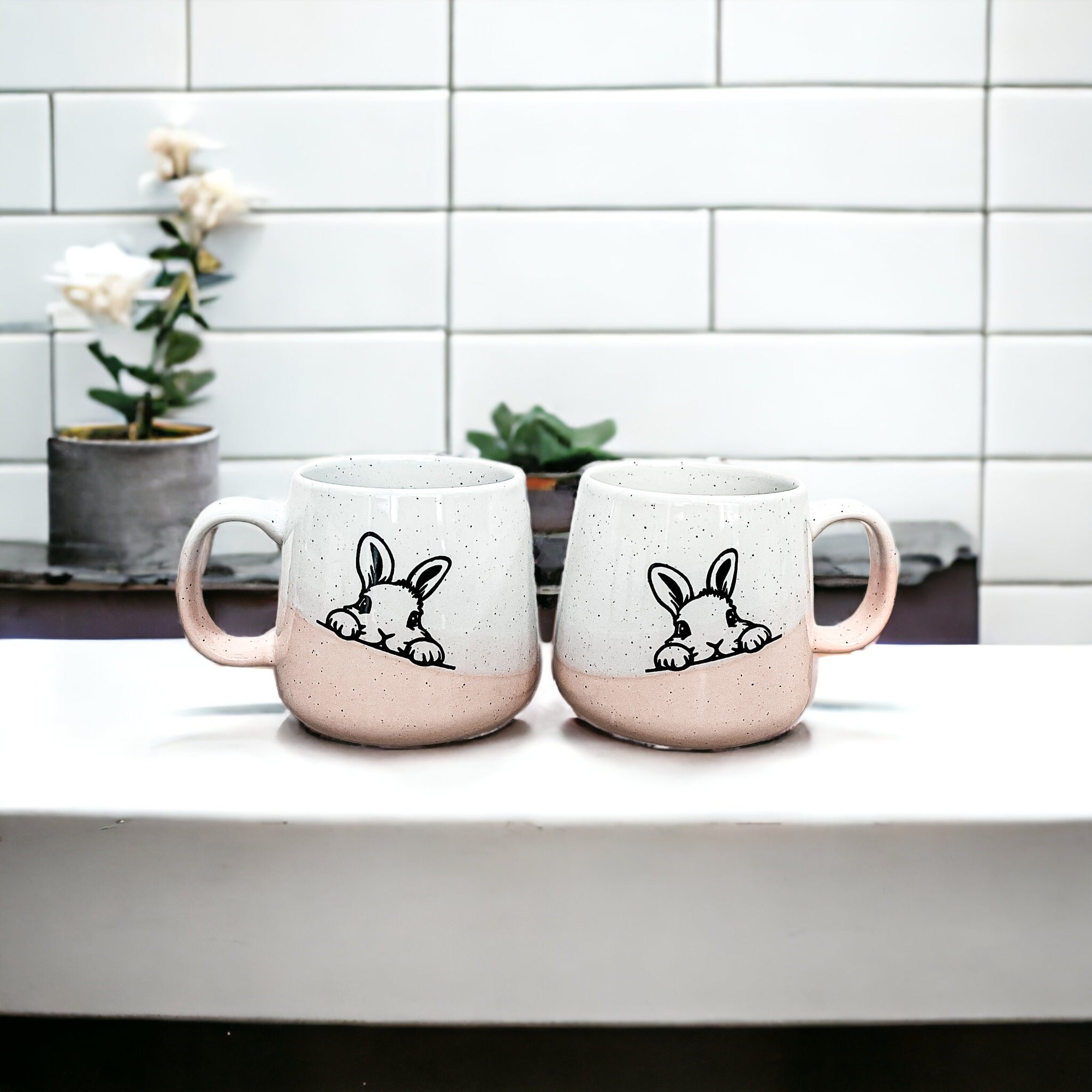 Handcrafted ceramic mug featuring a bunny silhouette and pastel pink base, perfect for coffee or tea.