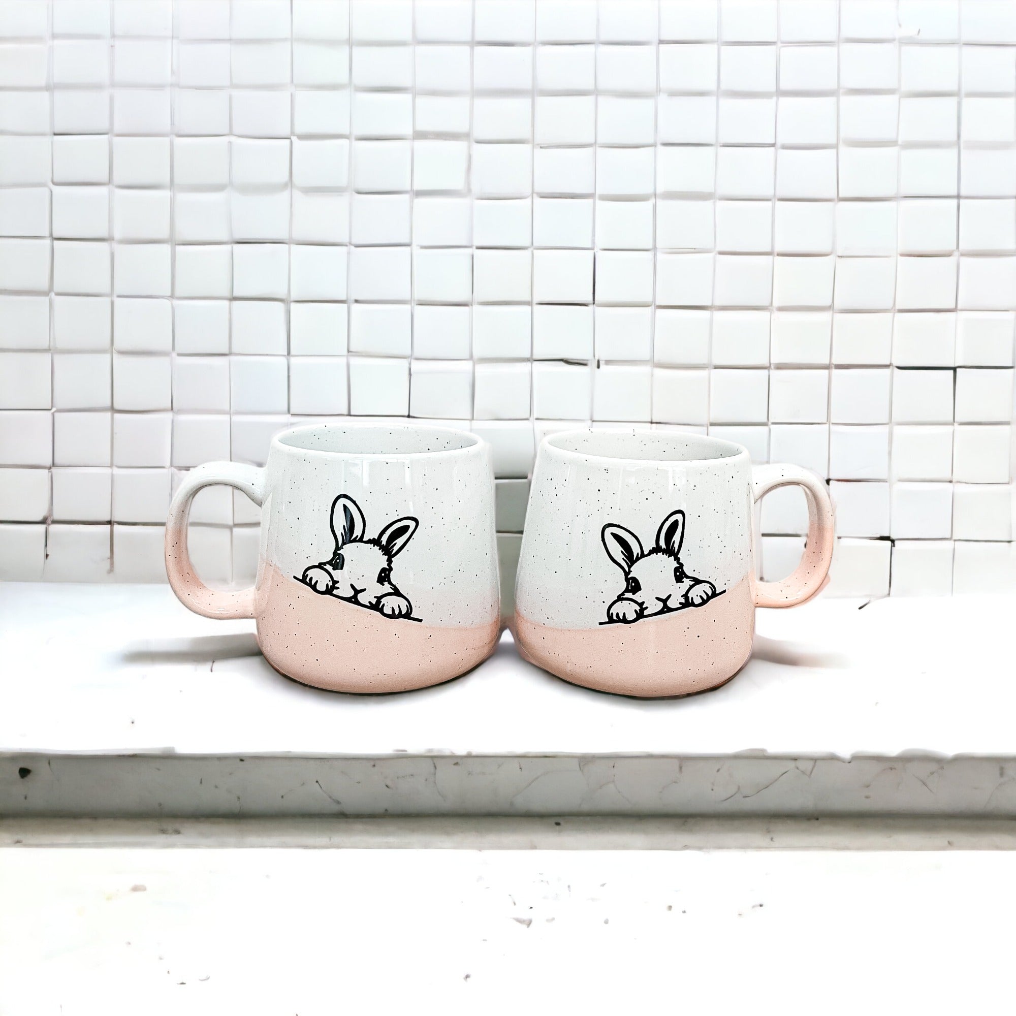 Handcrafted ceramic mug featuring a bunny silhouette and pastel pink base, perfect for coffee or tea.