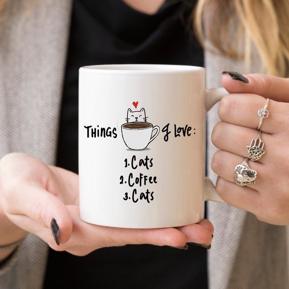 A humorous coffee mug featuring the text 'Things I Love: 1. Cats 2. Coffee 3. Cats', designed for cat lovers.