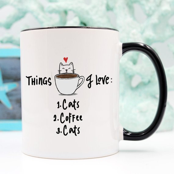 A humorous coffee mug featuring the text 'Things I Love: 1. Cats 2. Coffee 3. Cats', designed for cat lovers.