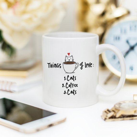 A humorous coffee mug featuring the text 'Things I Love: 1. Cats 2. Coffee 3. Cats', designed for cat lovers.